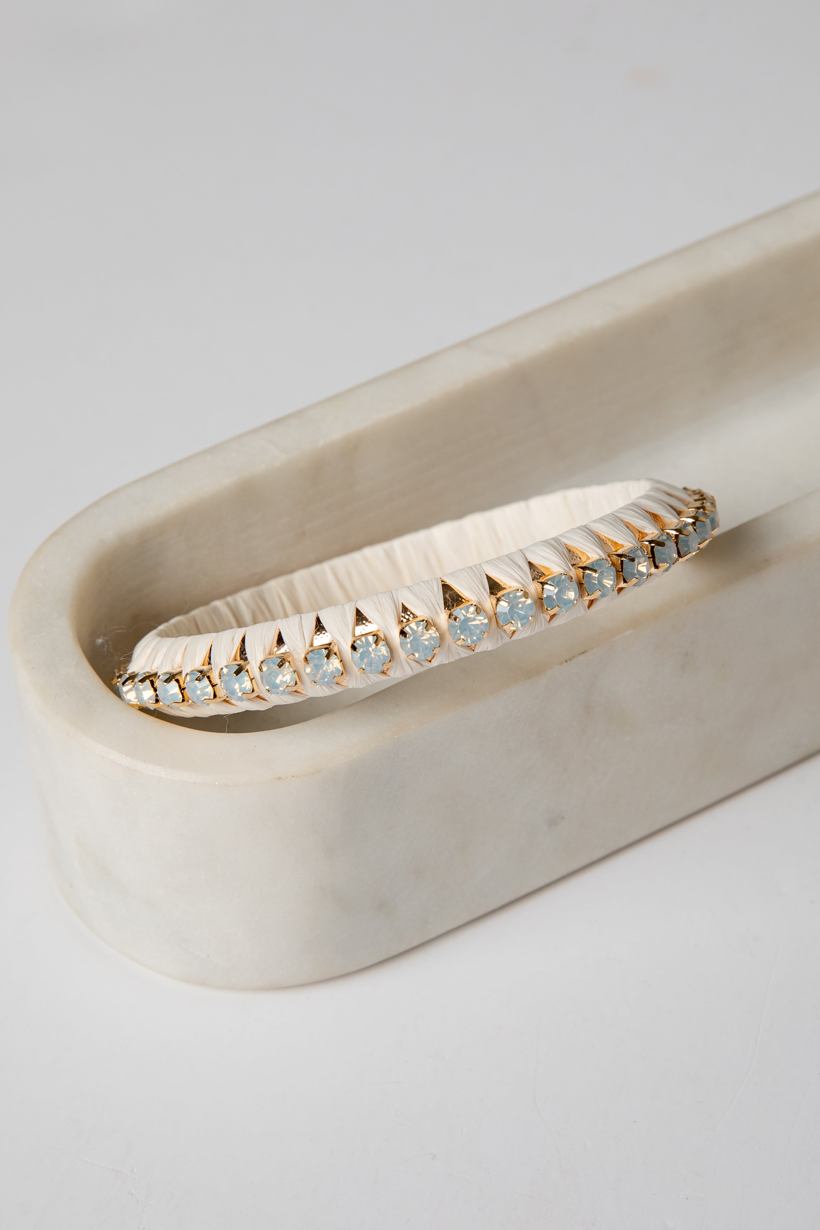 Gold ring with embedded stones on a white surface